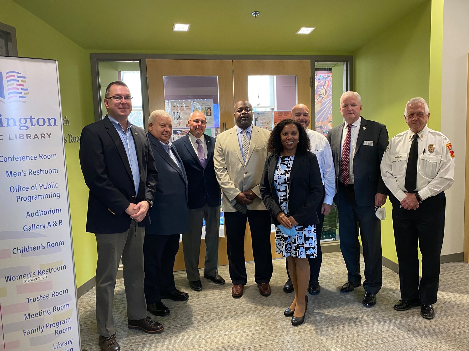 Pictured are (from left to right) Peter Gaynor, Norm Menard, Ray Laprad, Armand Randolph, Lieutenant Governor Sabina Matos, Bob Grimley, James Cunha, and Gerald Bessette.