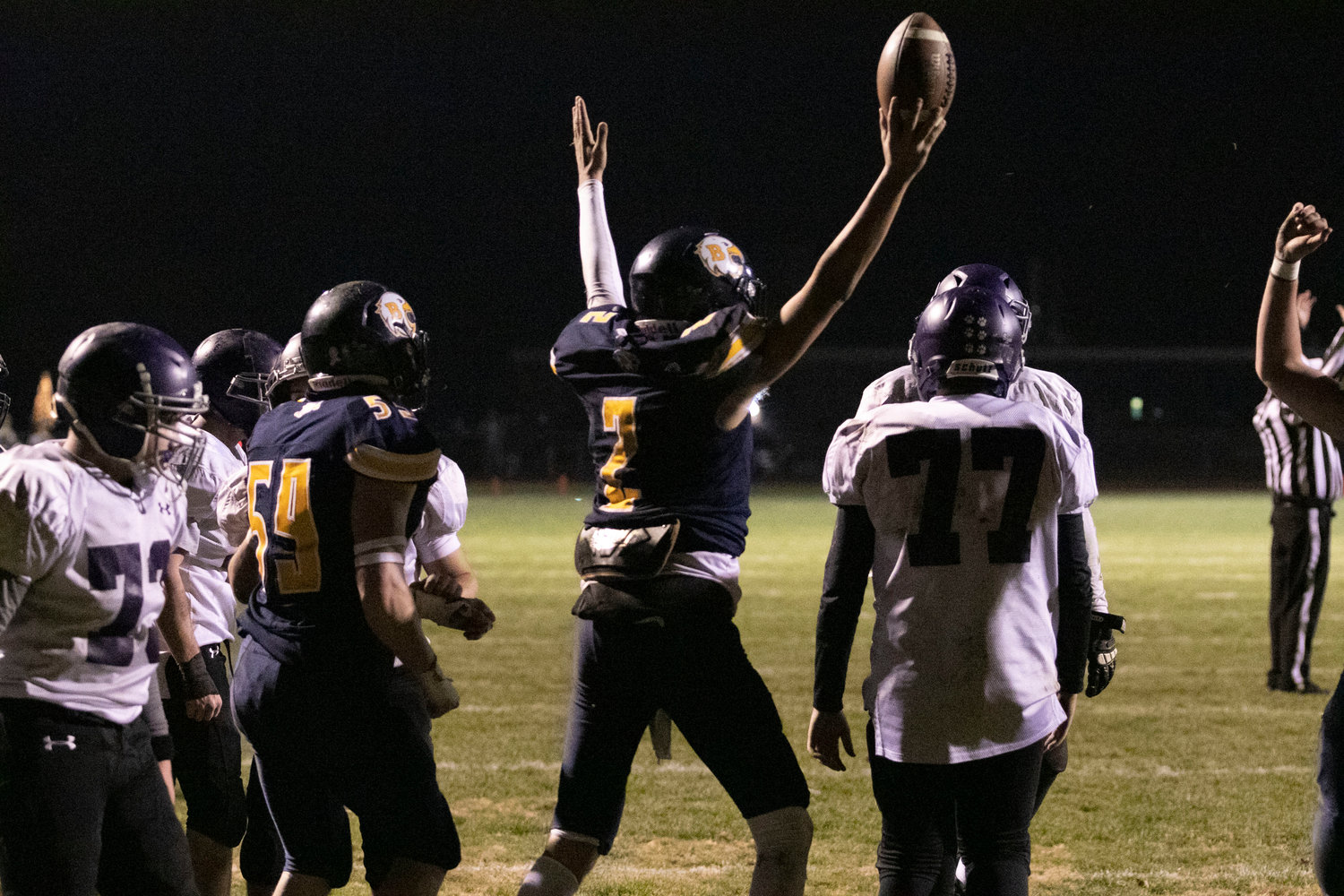 James Anderson holds up the football after scoring a touch down in the first quarter.