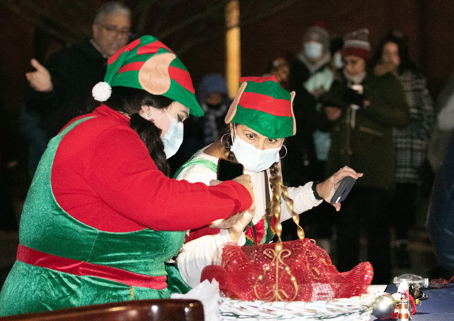 "Elves" Andrea Vegas (left) and Patricia Resende set up ornaments at the 2021 East Providence City Hall Tree Lighting ceremony.