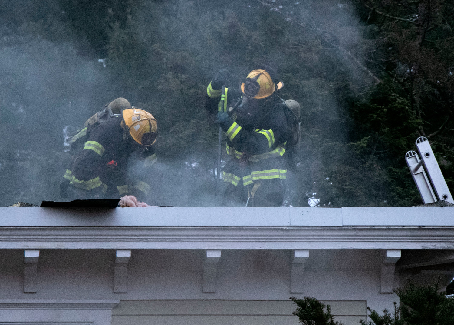 A plume of smoke rises from a hole that firefighters cut into the roof of a home on Alfred Drown Road as they battle a blaze on Saturday, Dec. 4. 
Firefighters from Barrington and four other departments responded to a house fire that began in the afternoon.