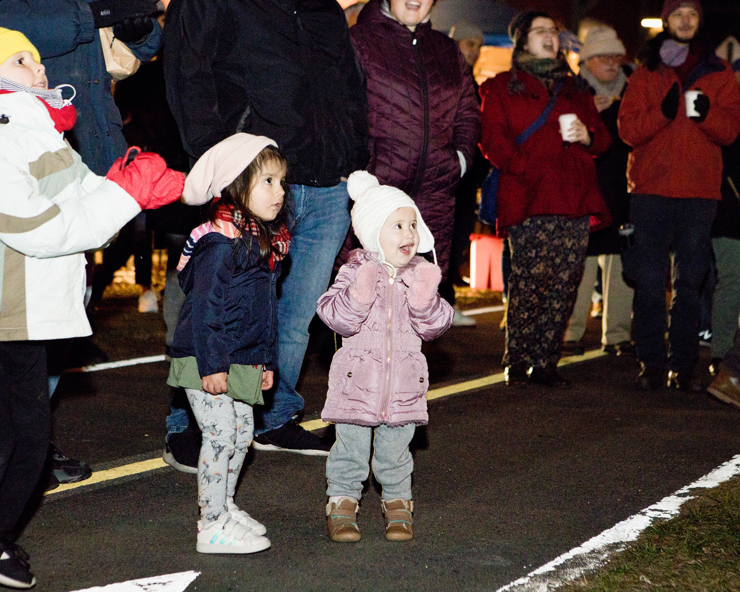 Mila Chuoke (left) and Marion Sackett dance and clap along to carols sung by "Voices of Christmas" during the Riverside Renaissance Movement Tree Lighting, Friday, Dec. 3.