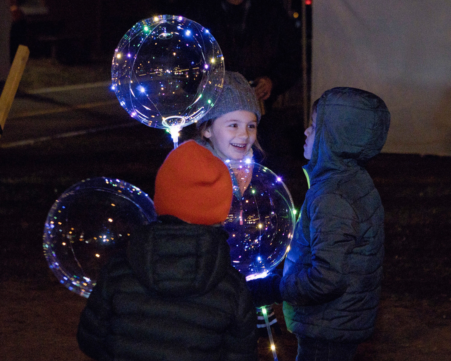 Jane Harding plays with her brother, Jack (orange hat), and friend, Abdiel Lugo while awaiting the lighting of the Riverside Renaissance Movement Tree, Friday, Dec. 3.