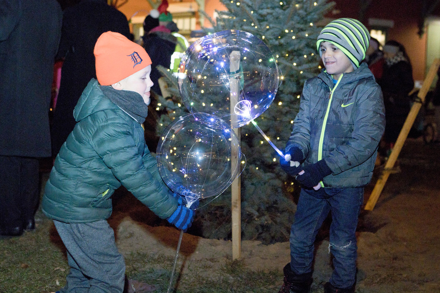 Jack Harding and Abdiel Lugo battle with light-up balloons while awaiting the lighting of the Riverside Renaissance Movement Tree, Friday, Dec. 3.