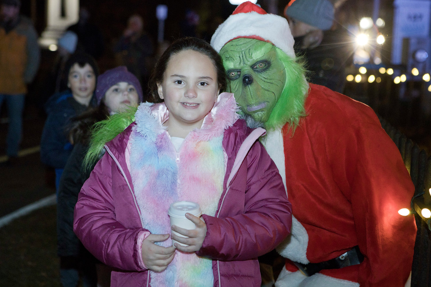 Olivia Horta poses for a photo with the “Grinch” (Dennis Carrier) during the Riverside Renaissance Movement Tree Lighting, Friday, Dec. 3.
