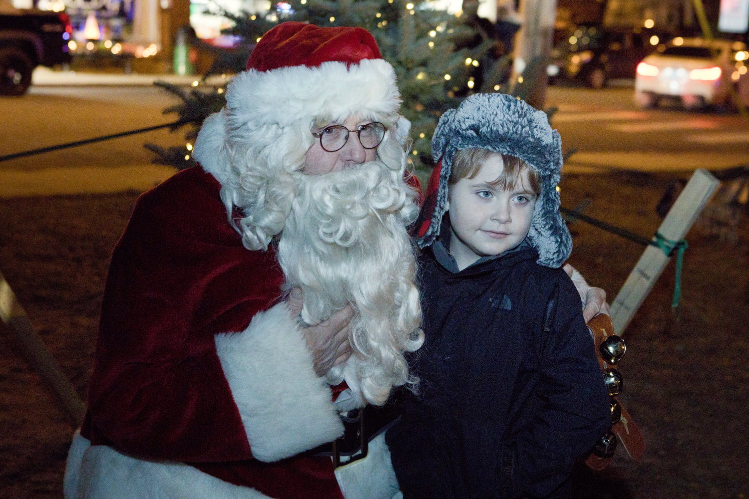 Peyton Surette, 6, poses for a photo with Santa while attending the Riverside Renaissance Movement Tree Lighting, Friday, Dec. 3.