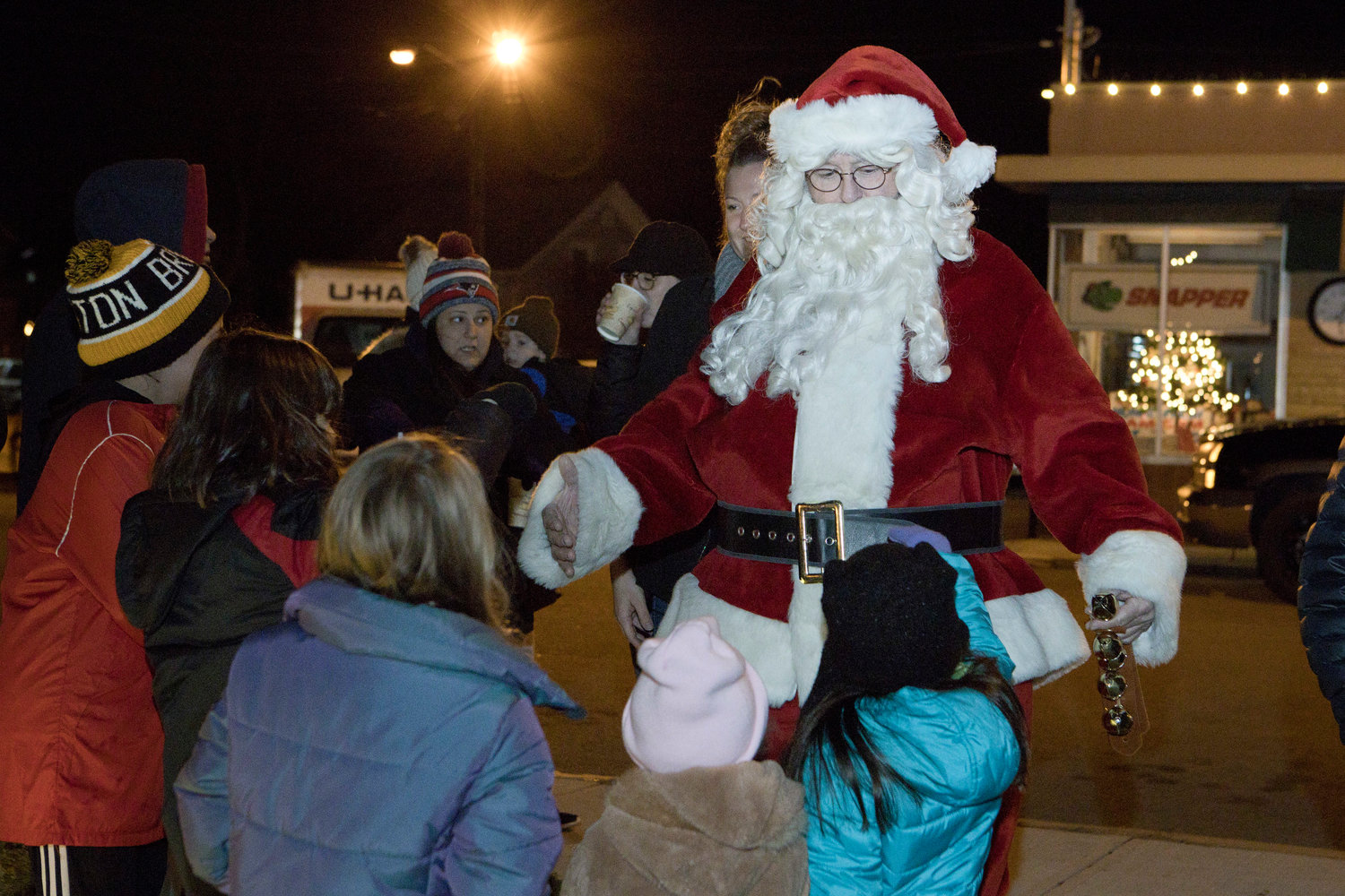 Santa is swarmed by children as he arrives at Borealis Coffee Roasters, for the Riverside Renaissance Movement Tree Lighting, Friday, Dec. 3.