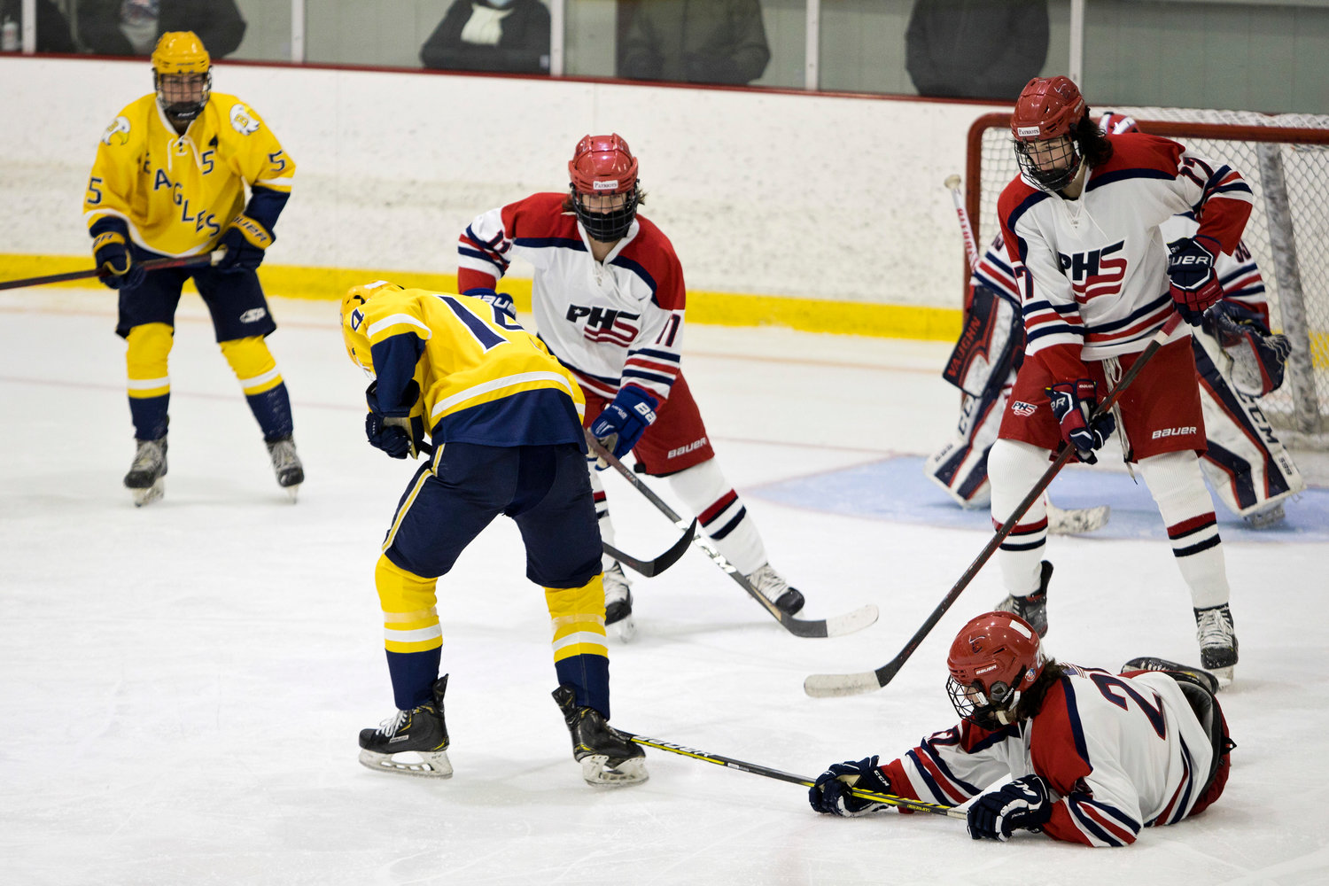 Joe Rocco (on the ice) reaches his stick out to stop a Barrington sho on goal.