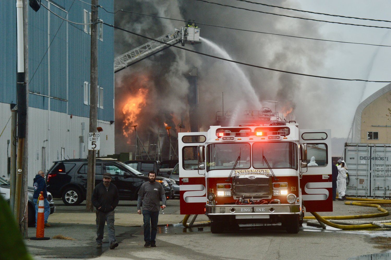Firefighters battle back flames from a boat at Hickley Yachts in Portsmouth late Friday morning, Dec. 10.
