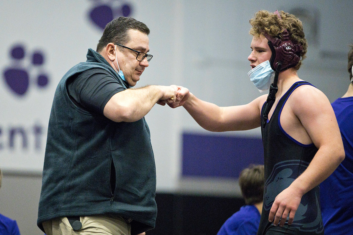 Huskies new head coach Mike Perreira gives a fist bump to James Thibaudeau after his match on Saturday.