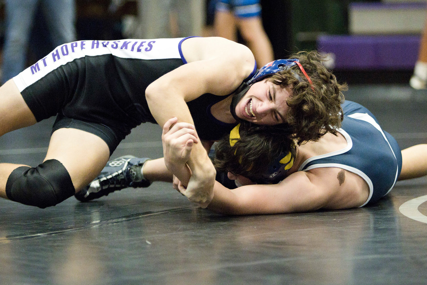 Ethan Martel competes against Needham in the 126 lb. weight class,
Saturday.