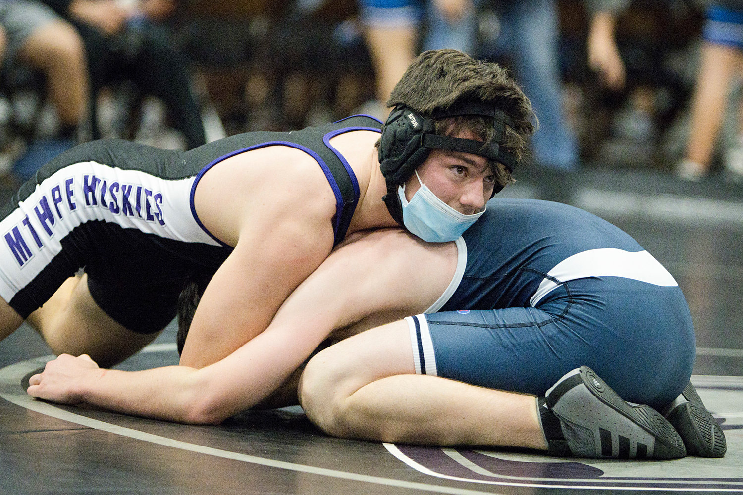 Riley Howland eyes the clock while controlling his Needham opponent
in the 138 lb. weight class, Saturday.