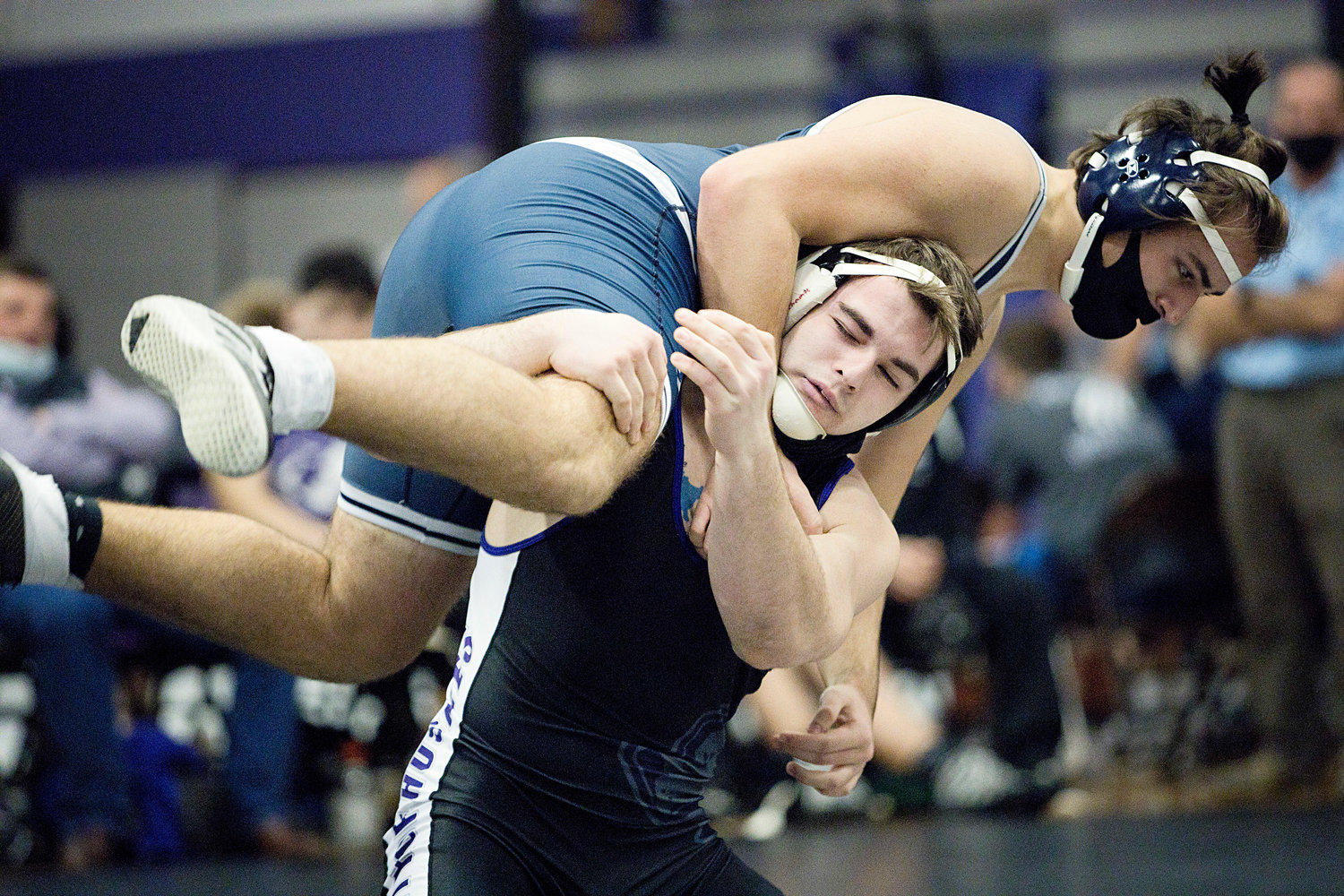 Senior 195 pound wrestler Lucas Brum hoists a Needham opponent over his head during the Sharon Lombardo tournament on Saturday.