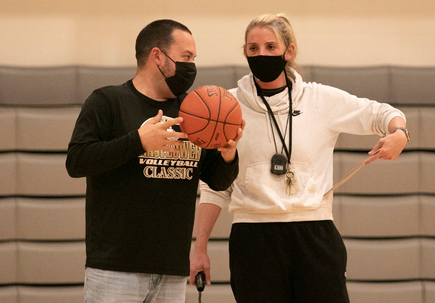 Athletic director Jason Pacheco (left) chats with coach Jen Gargiulo during practice.