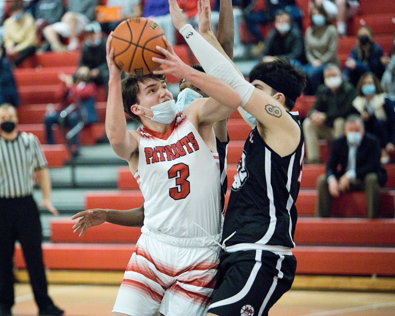 Jack Downing is pressured by a Mt. Pleasant opponent while trying to make a shot.
