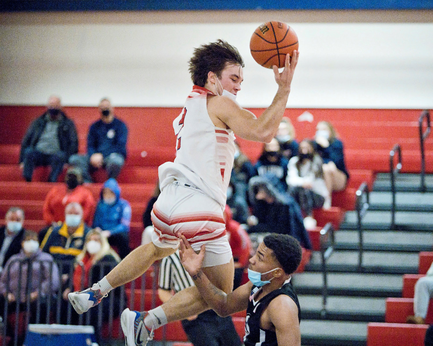 Portsmouth High’s Benny Hurd soares over a Mount Pleasant opponent during the Patriots’ home game Friday night. Hurd was the high-scorer for the Patriots with 20 points, but Portsmouth lost, 57-51.