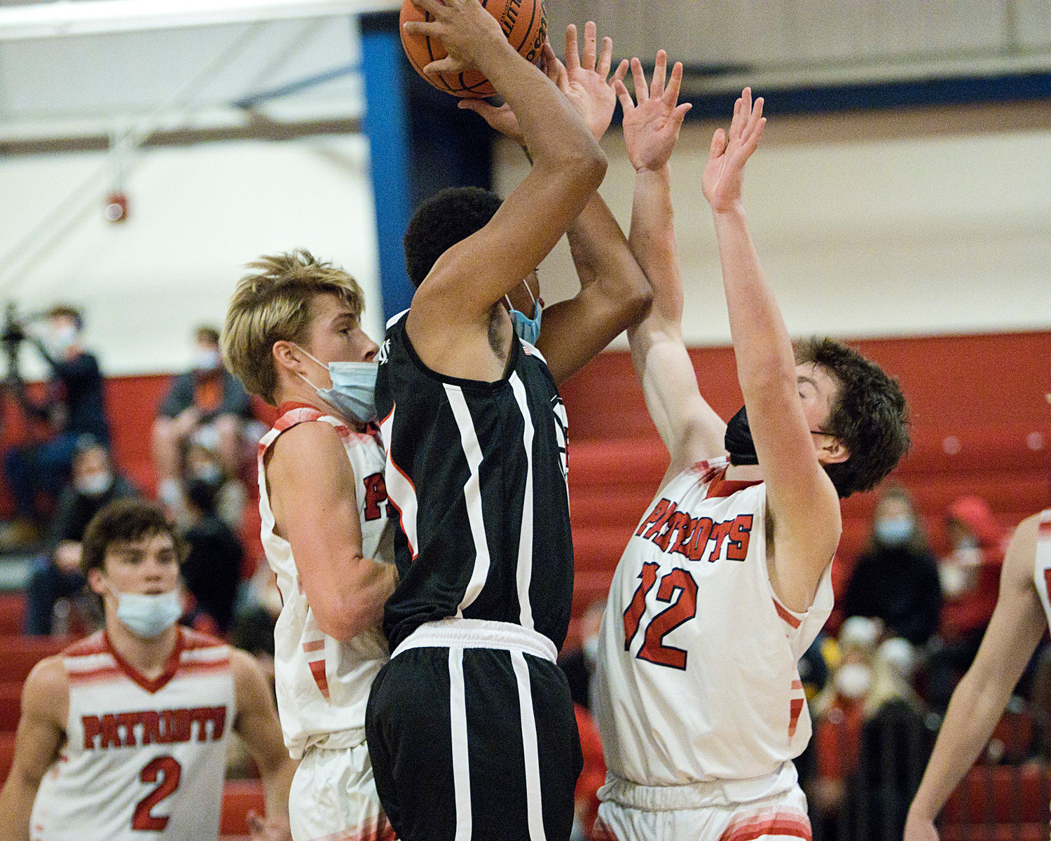 Portsmouth’s Jeff Brady (left) and Luke Brennan attempt to prevent a Mt. Pleasant opponent from making a shot.