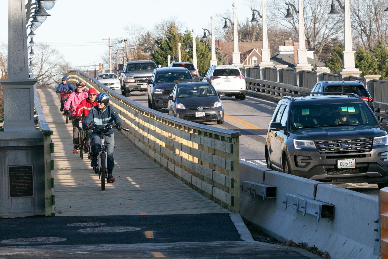A group of riders out for a cruise on a recent Friday afternoon, coast down the newly built wooden boardwalks on the Barrington River Bridge. The riders yelled, "Well done," as they passed, to a worker and a Barrington policeman who were posted at the bottom of the bridge to look after the cross walk.