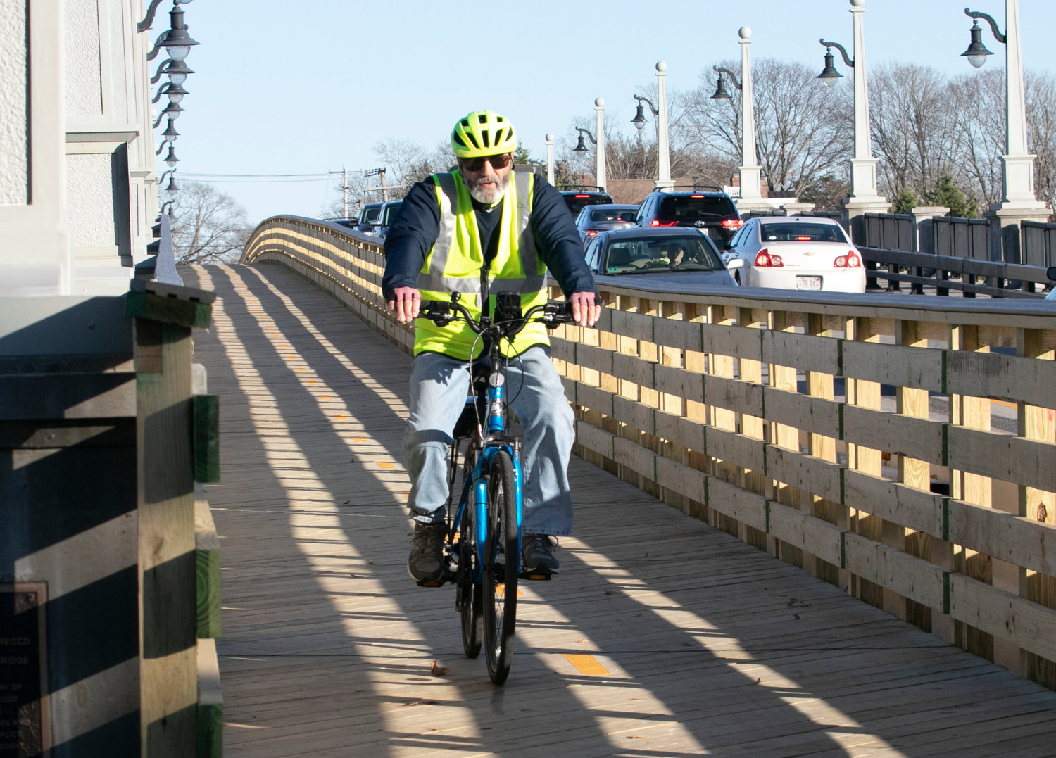 John Vinnitti, of Riverside, rides down the newly built wooden boardwalk on the Barrington River Bridge after a trip to Bristol and back. Once on the other side he said that, "It feels comfortable on the bridge. Wide and safe. They did a nice job."