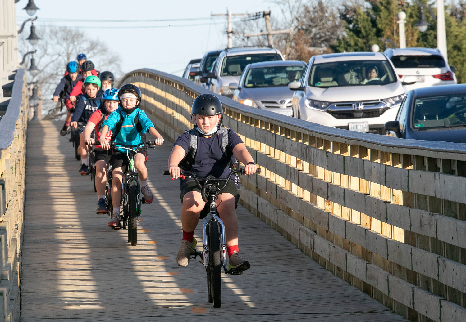 Students from Hampden Meadows School ride over the wooden boardwalk on the Barrington River Bridge on Friday afternoon.