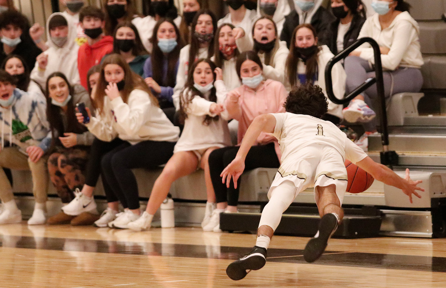 Blue Devils fans look on as Junior guard Hunter Brodeur saves the ball from going out in the fourth quarter with the Wildcats clinging to a three point lead.