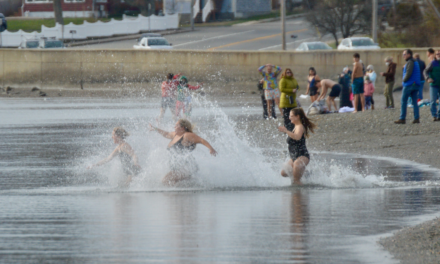 Emma Harvey, Brooke Saunders and Christina Halliday (from left) splash in the waters at Island Park Beach as they take a New Year’s Day dip on Jan. 1, 2021. Although there was no “official” New Year’s Day dive that day, several people jumped in anyway.