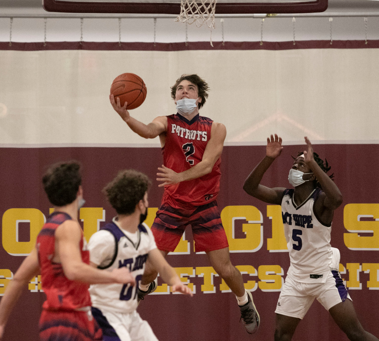 Ben Hurd attempts a reverse layup from under the basket during the Patriots’ game against Mt. Hope at Tiverton High School Tuesday. Portsmouth cruised, 60-41.