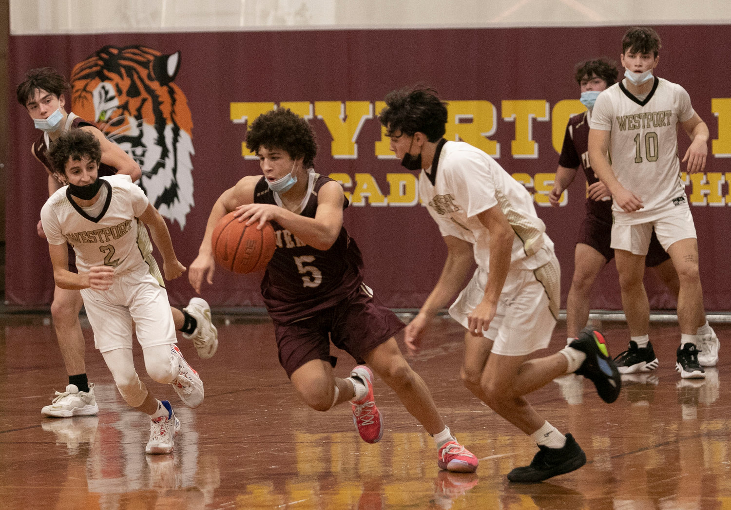 Tigers guard Tristan White (middle) dribbles up court after securing a rebound. 