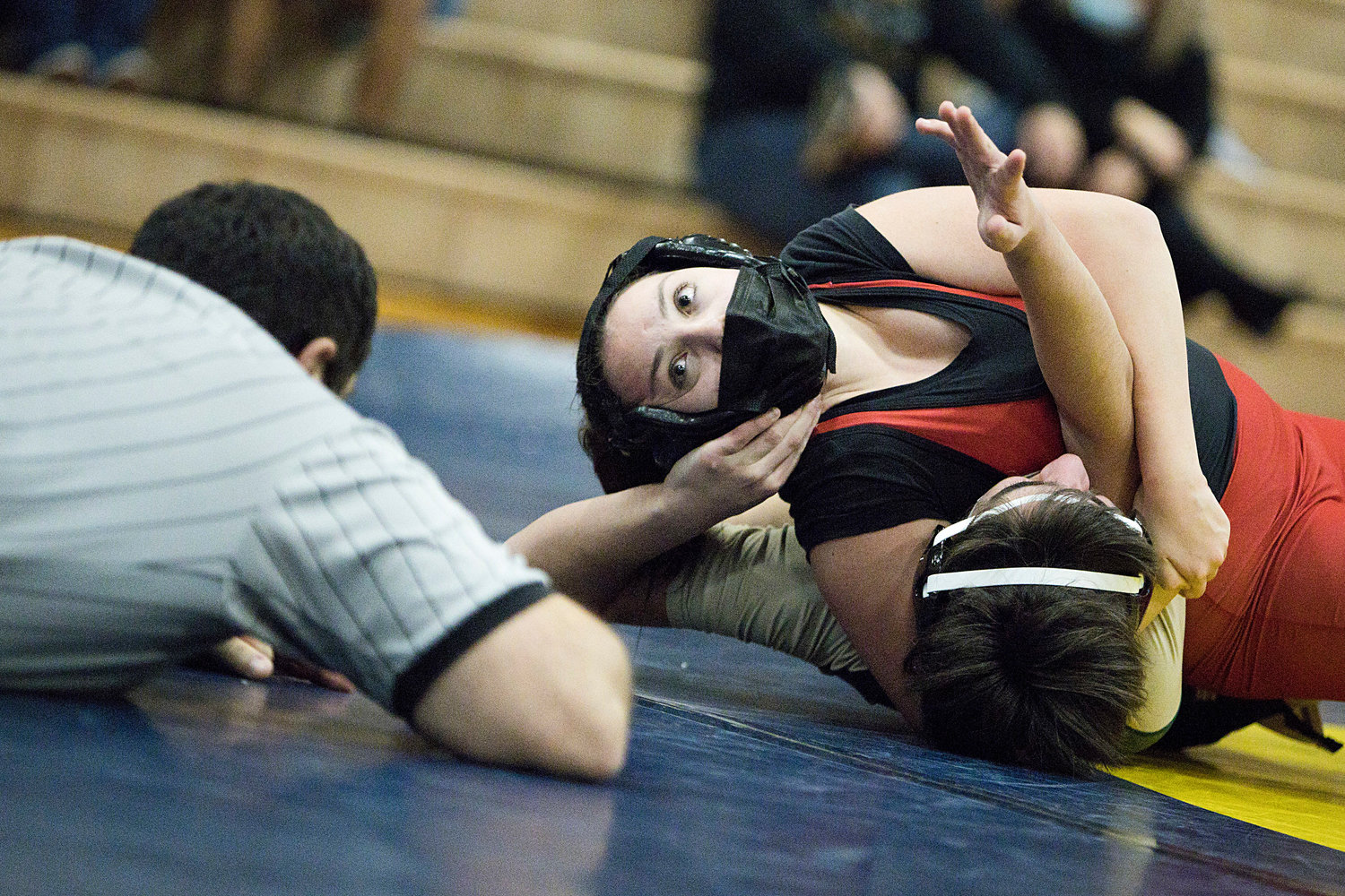 Ciara Nunes works to pin a Hendricken opponent while competing in the 132 weight class.
