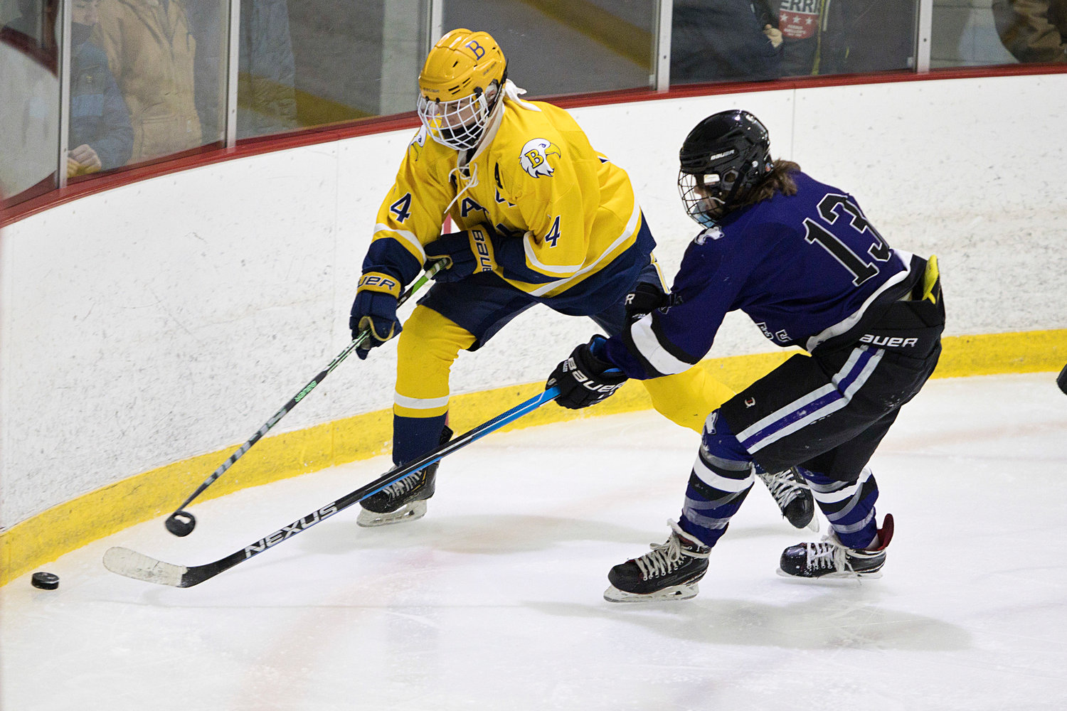 Barrington’s Brenen Gazeryan is pressured by a Mount hope opponent while controlling the puck along the boards.