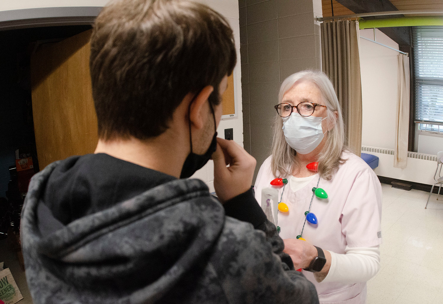 Head nurse Ellen Estrella supervises as a Mt. Hope High School student administers his own Covid test.