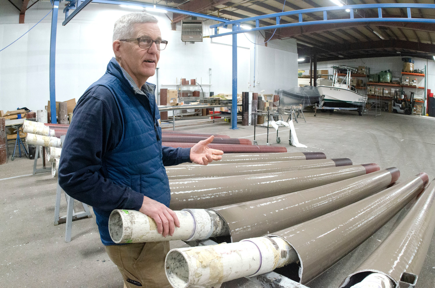 Company president Mark Pearson talks about how they manufacture and paint this series of pilings inside their Somerset facility.