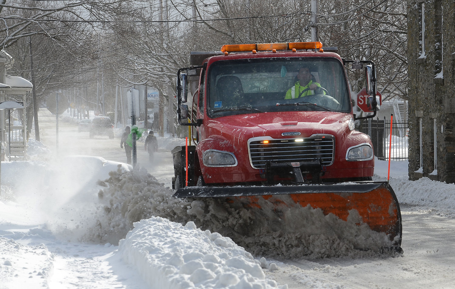 A plow truck clears a road in Warren after a snow storm in 2020.