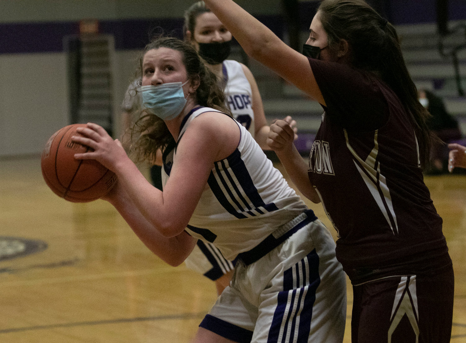 Freshman Emily Moran looks to make a pass under the hoop. 