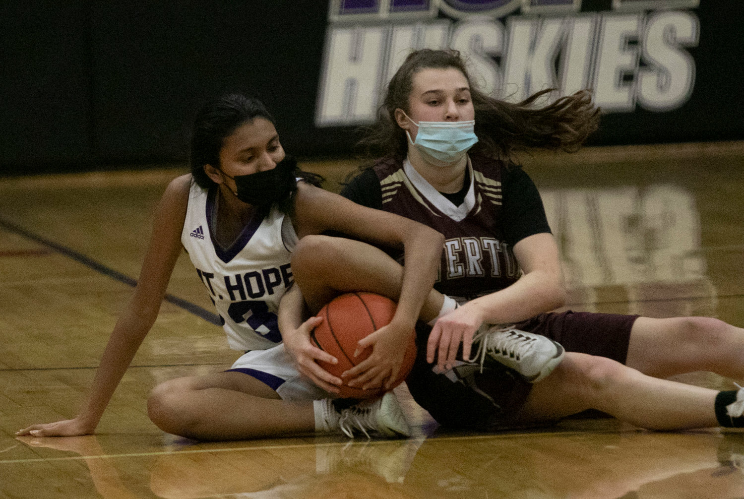 Aditi Mehta fights for a loose ball with Tiverton's Abby Monkevicz.