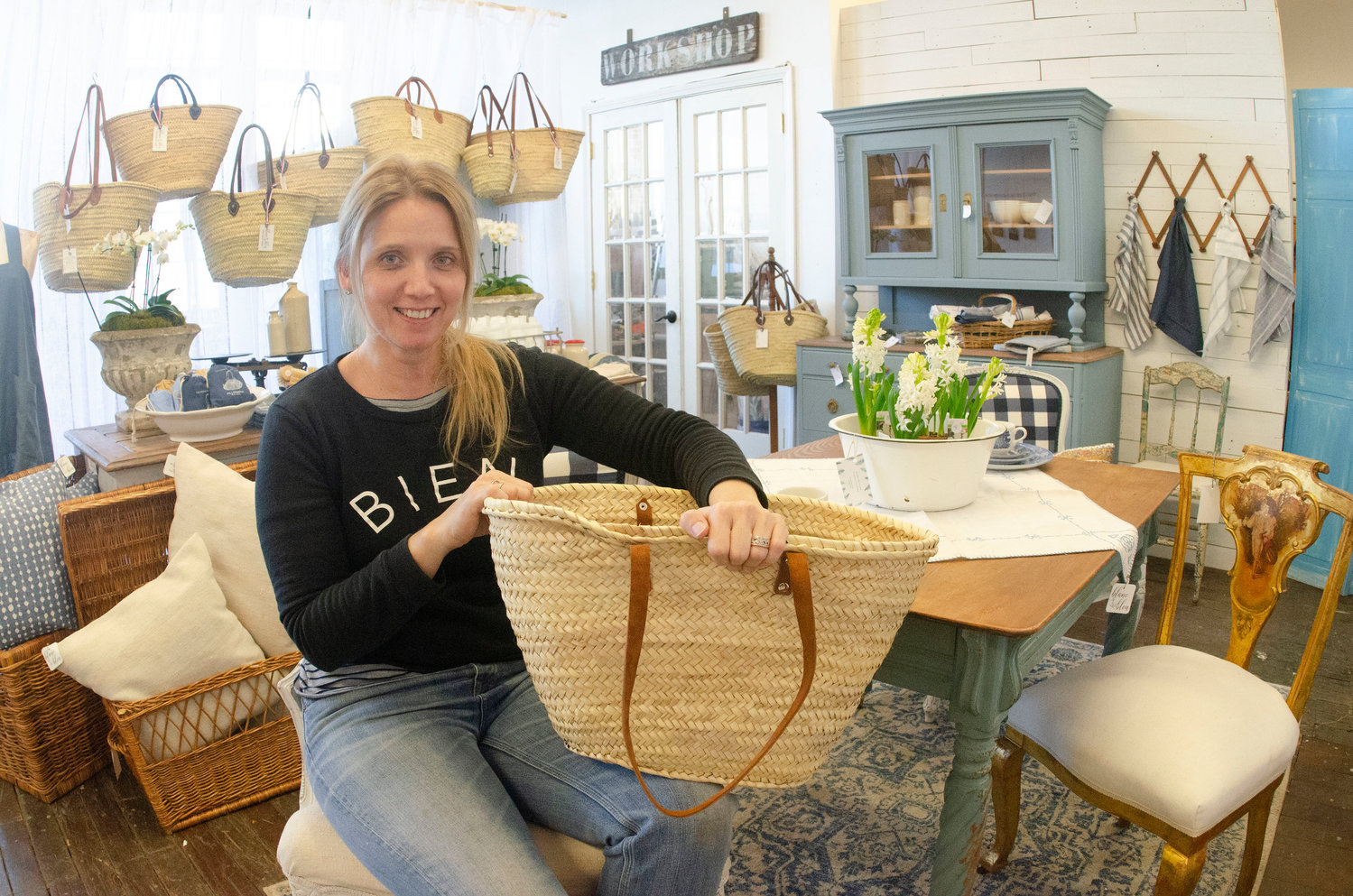 Blanc & Bleu proprietor Jenna Kinghorn with a French Market basket, one of many items sourced from Europe for both her online retail shop and her brick and mortar boutique in Unity Park. “I believe in things that are well-made and purposeful,” she said.