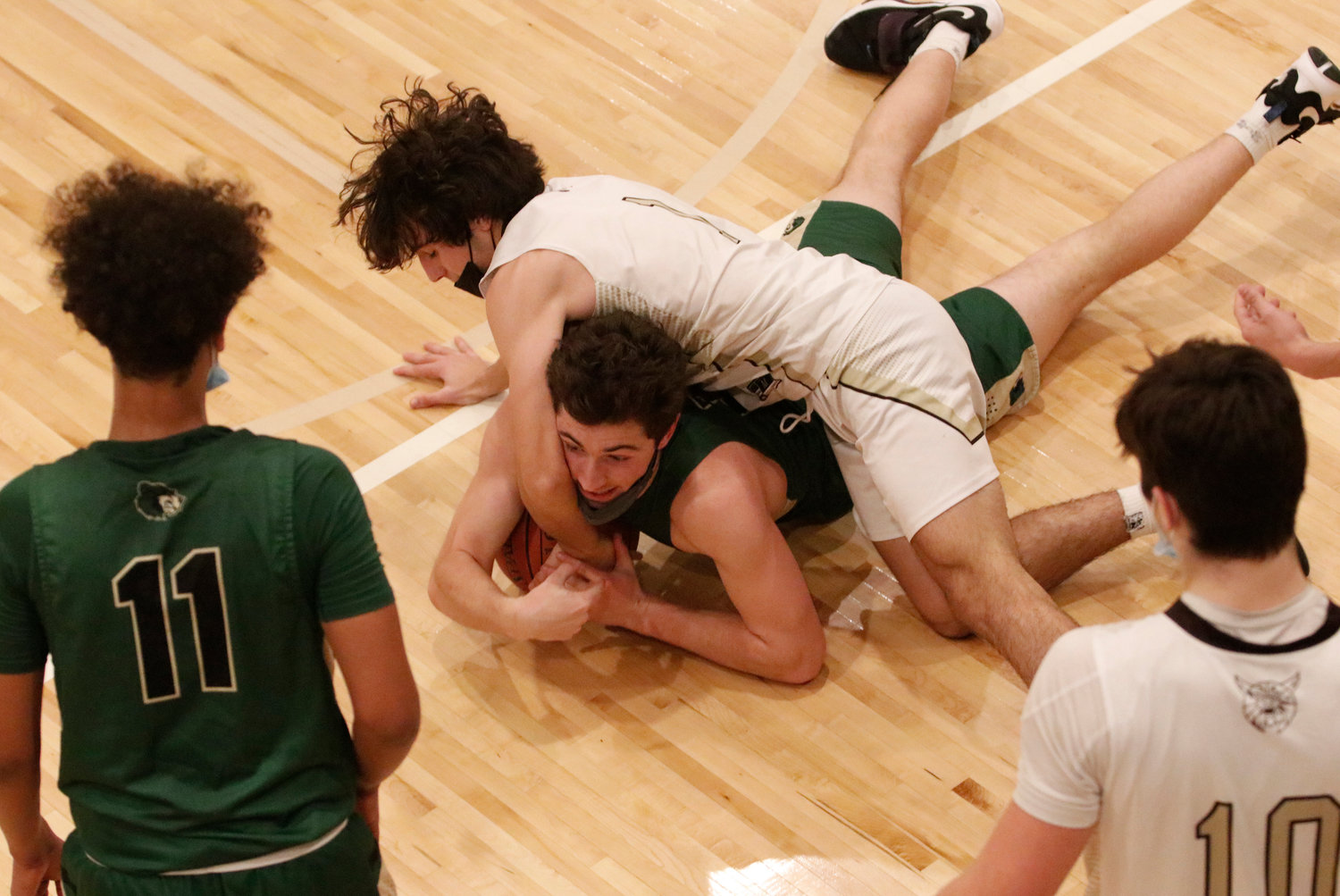 Hunter Brodeur dives on top of a Bears' player to get to a loose ball. 
