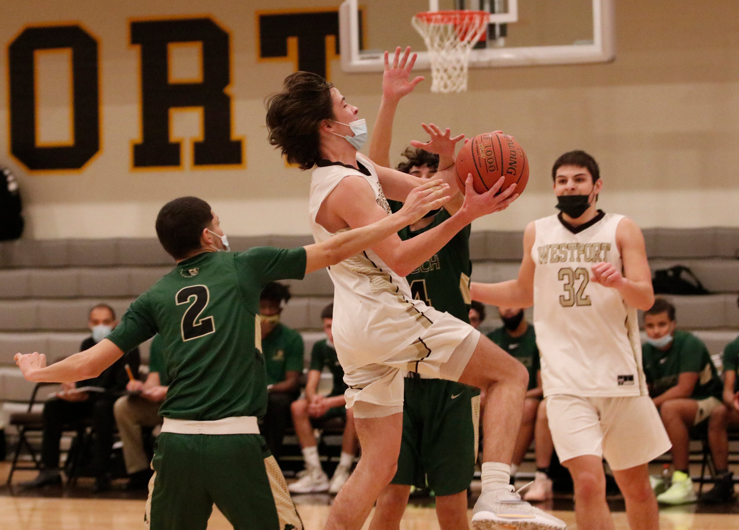 Cam Leary (left) flies in for a layup with teammate Ben Poitras (right) looking on. 