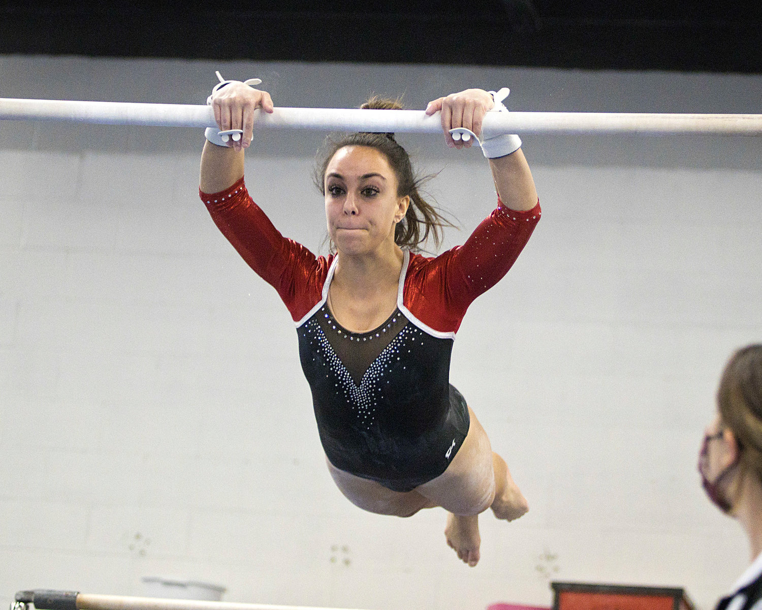 Haley Massa swings up to the high bar during the Saturday, Jan. 22, meet against  Portsmouth, Middletown, and Mt. Hope. Massa earned a 6.6 on the event and an all-around score of 30.95.