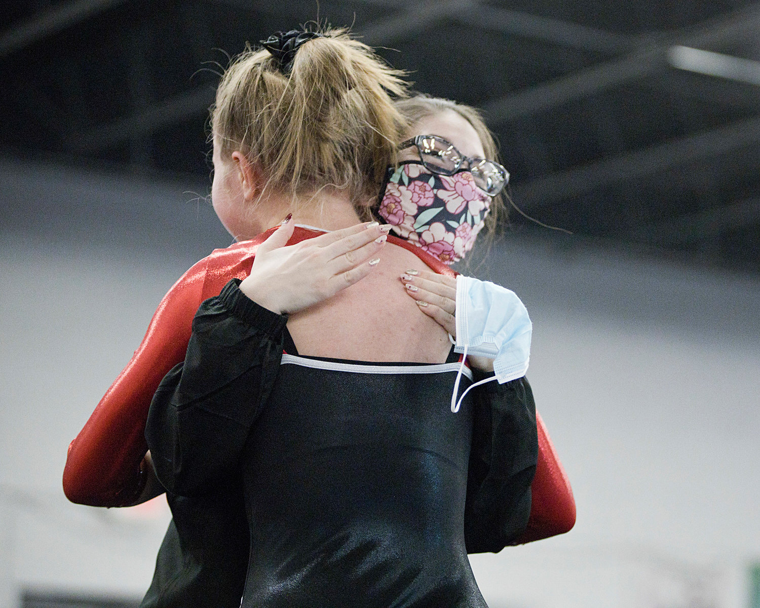 Assistant coach Vickie Lombardi congratulates Brettyn-Olivia Newsome on her floor routine.