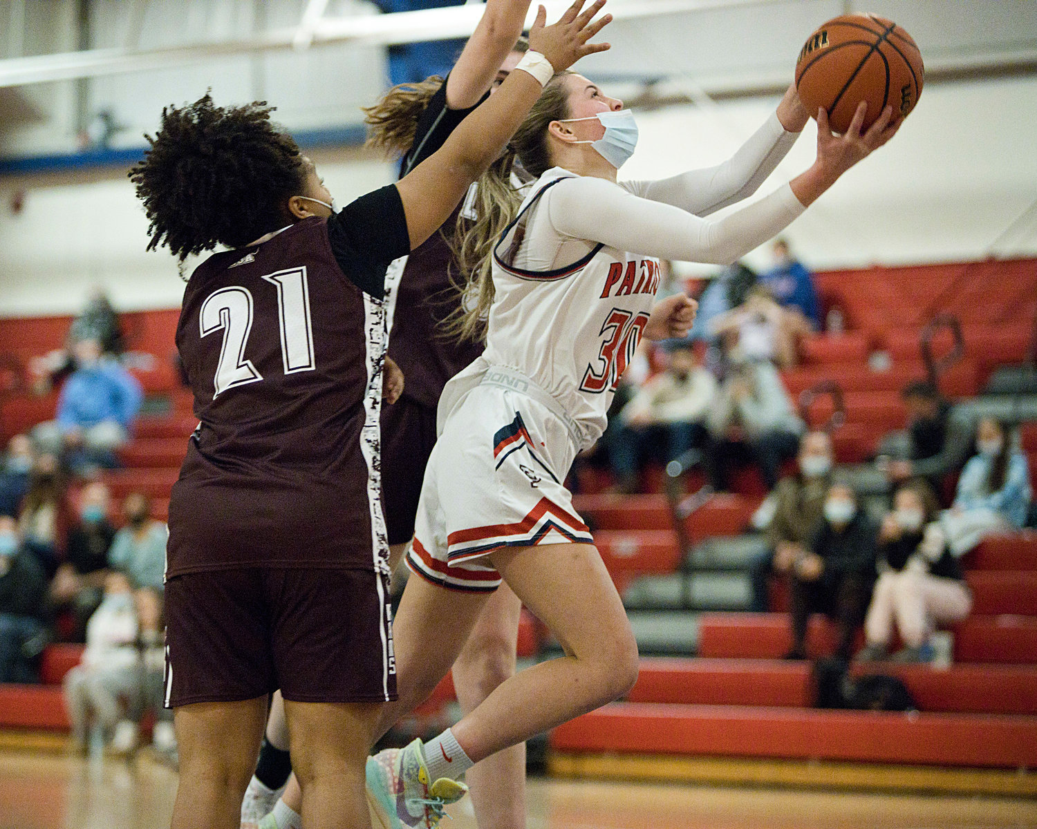 Ava Hackley splits a pair of La Salle opponents while going in for a layup.