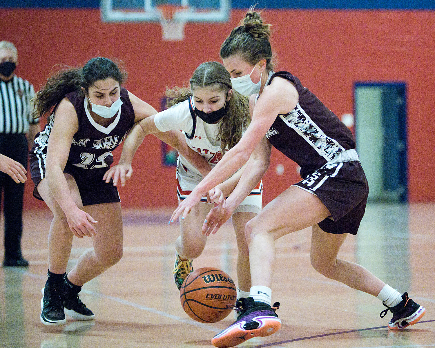 Ava Moore races a pair of La Salle opponents to a loose ball.