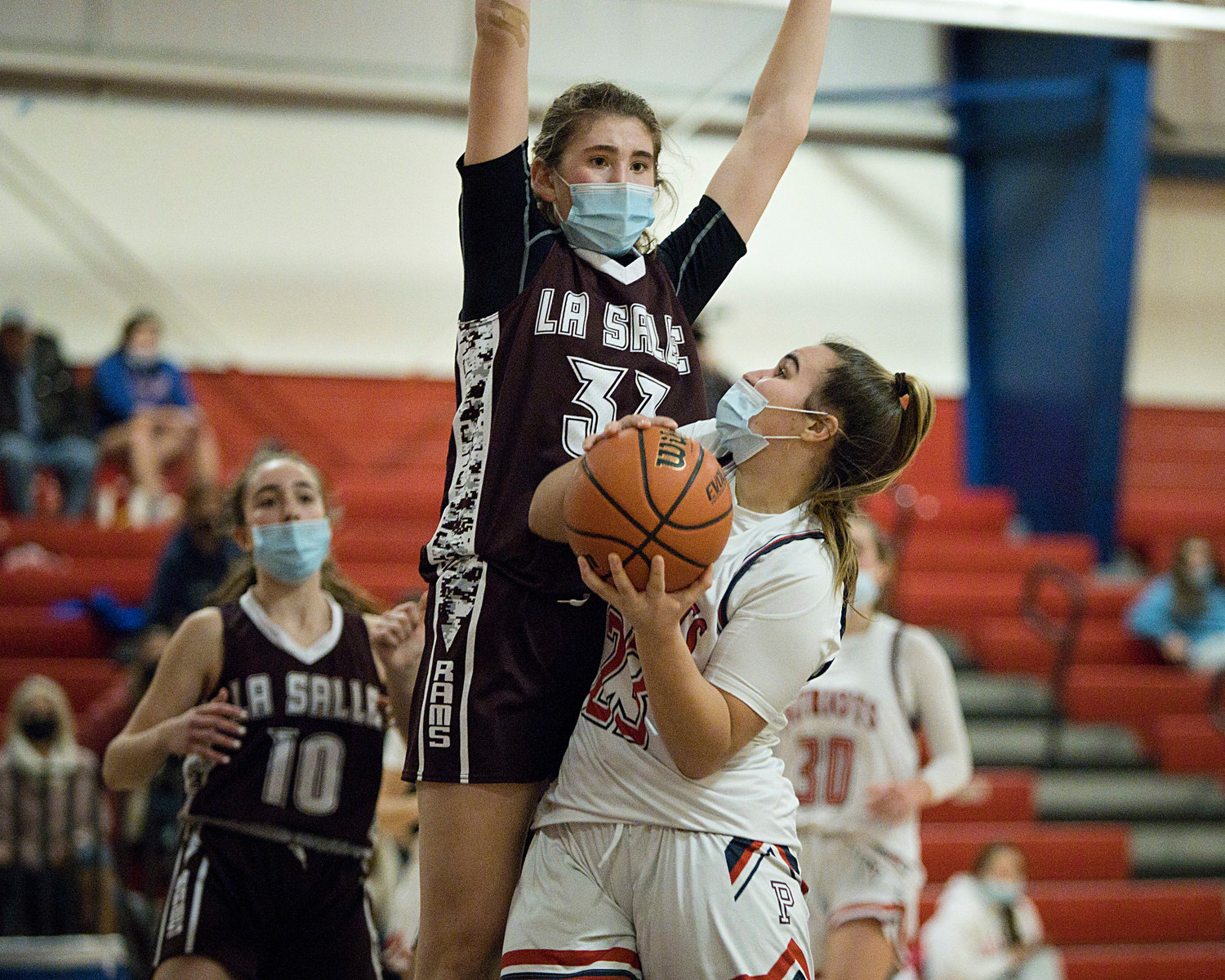 Emily Maito eyes the basket as a La Salle defender towers over her.