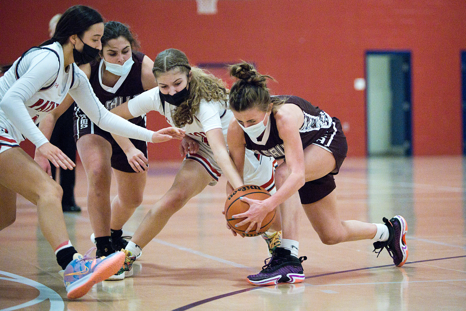 Olivia Durant and Ava Moore battle La Salle opponents for possession of a loose ball.