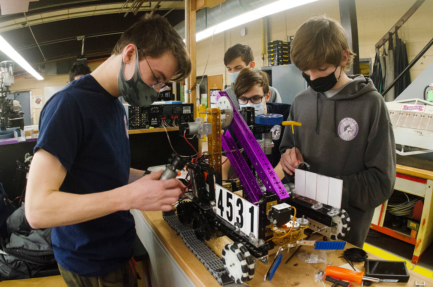 Declan Reed (left) and Michael Thibault repair their team's robot.