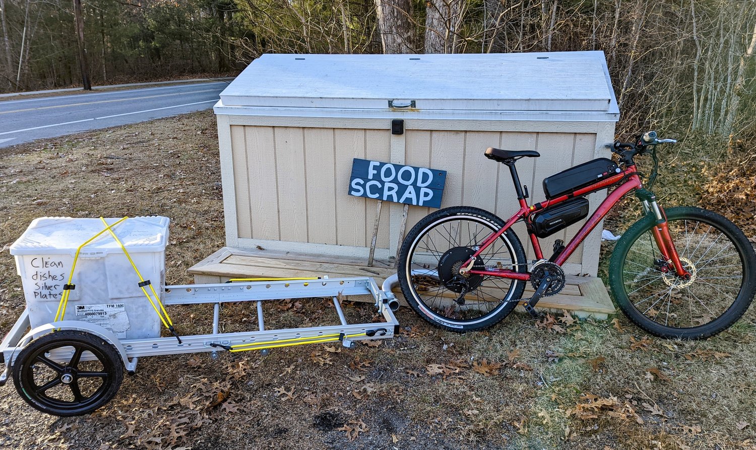Barrington Farm School volunteers transport the donated food scraps from the Kent Street collection bin to the farm school property using an electric bicycle and trailer.