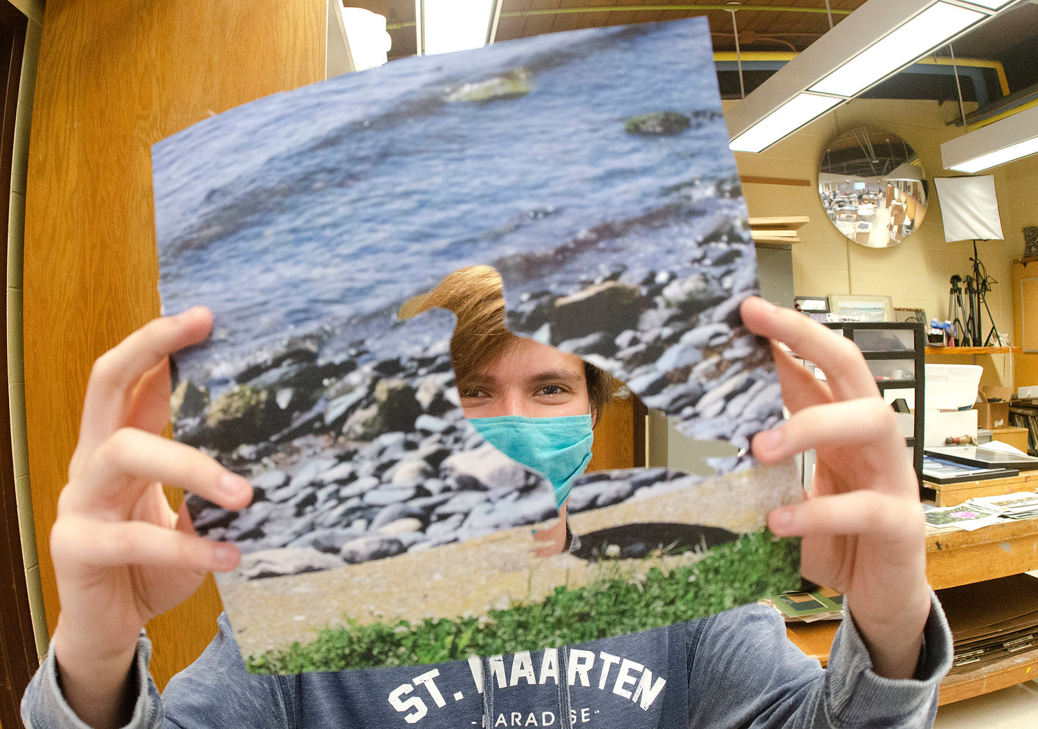 Brandon Nelson works on what he calls a mix of trash and photography for a photo collage during art class last week.