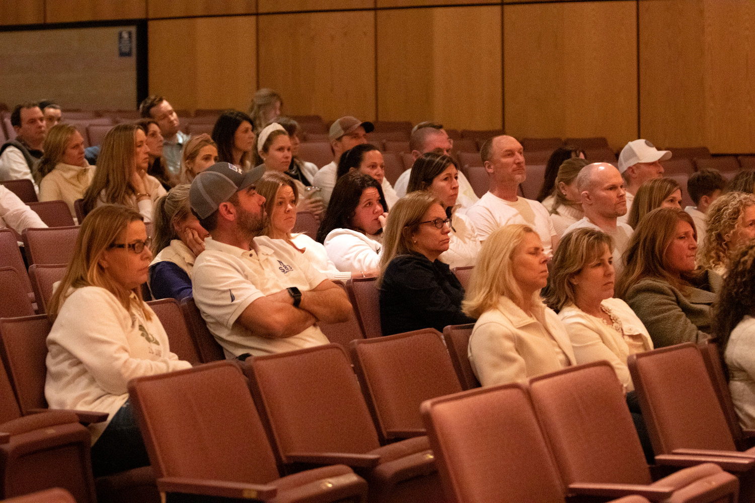 A crowd of people attend the appeal hearing for the fired Barrington teachers — many people in the audience wore white to show their support for the teachers.