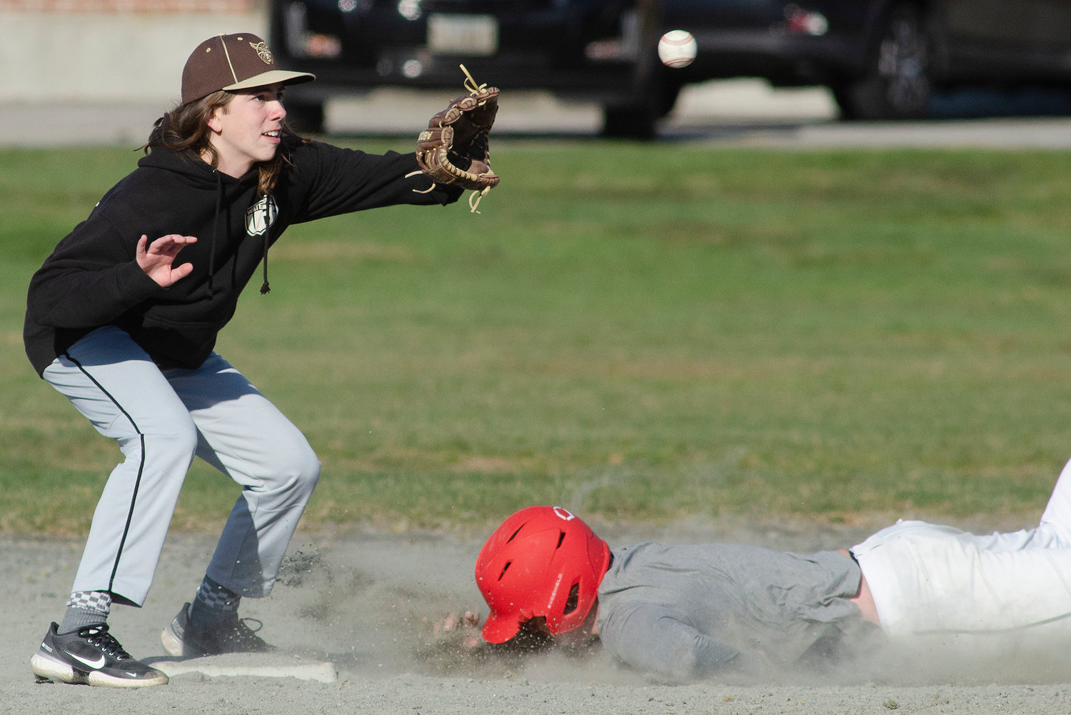 Matt Costa slaps a tag on Tiverton baserunner Cam Rego as he attempts to steal second base.