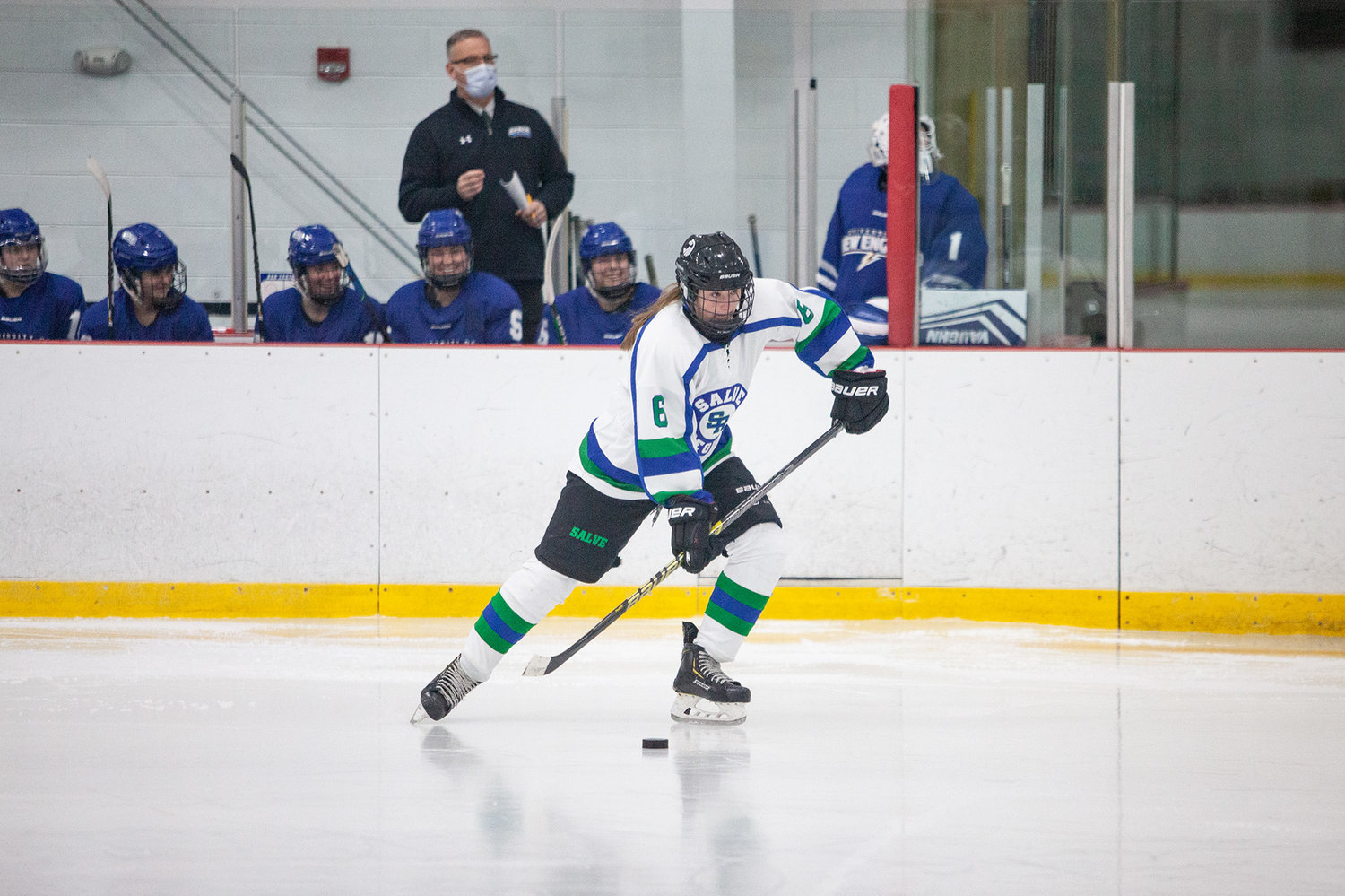 Barrington High School graduate Maddie Cox carries the puck up the ice for Salve Regina this winter.