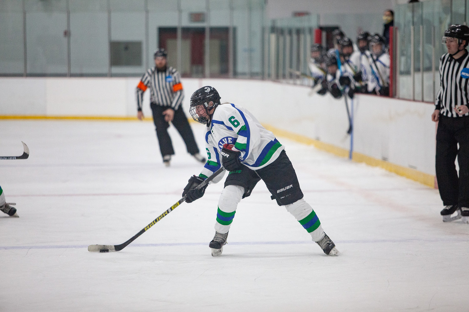 Maddie Cox, a former standout for the East Bay Co-op Girls Hockey team, looks to pass the puck to a teammate during a Salve Regina hockey game.